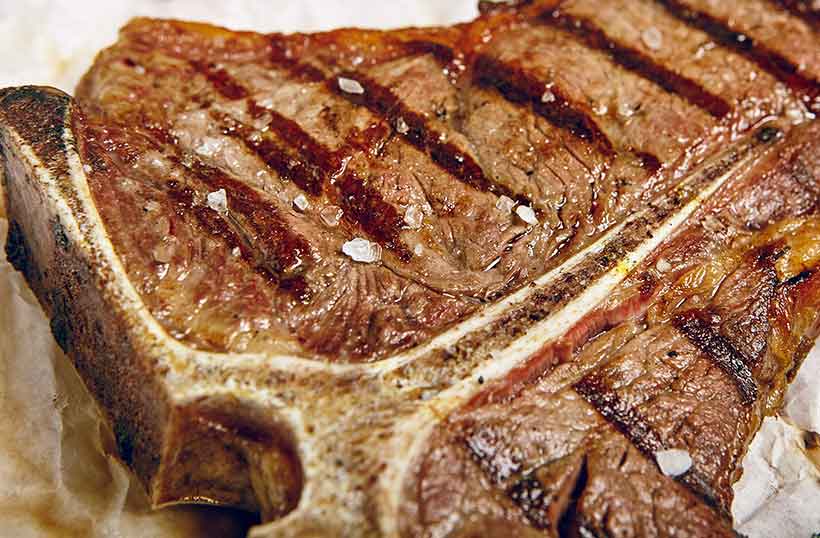T-Bone Steak: A Steak and Eggs Diet Can Be Tasty Picture of a Cooked T-Bone Steak Ready to Eat.