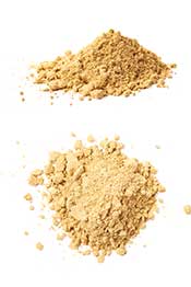 Dried Ginger: This Warming Spice Packs a Huge Amount of Flavor. Pile of Dried Ginger on a White Surface,