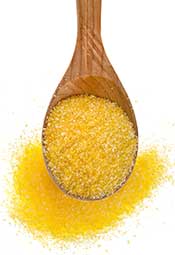 Maize Flour: Powdered Corn is a Dietary Staple in Many Countries. Yellow Maize Flour on a Wooden Spoon.
