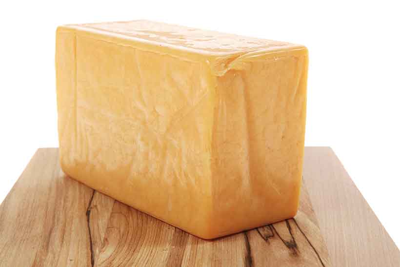 Cheese Contains Beneficial Fermented Dairy Fat. A Block of Aged Vintage Cheddar Cheese.