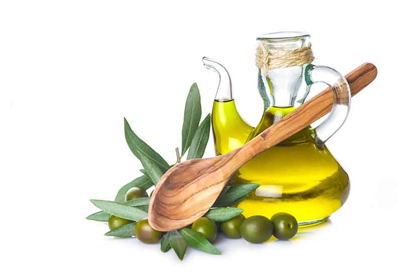Extra Virgin Olive Oil: The Healthiest Cooking Fat In the World? A Bottle of Extra Virgin Olive Oil With Green Olives.