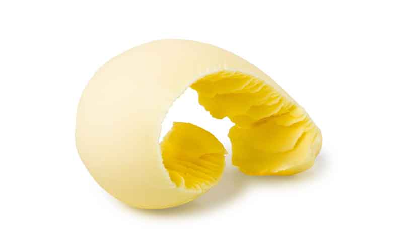 Butter: A Dairy Fat Rich In Fat-Soluble Vitamins. A Curl of Fresh Yellow Butter.