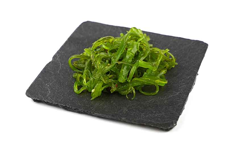 Seaweed: A Nutritious and Healthy Sea Vegetable. Seaweed Salad On a Black Plate.