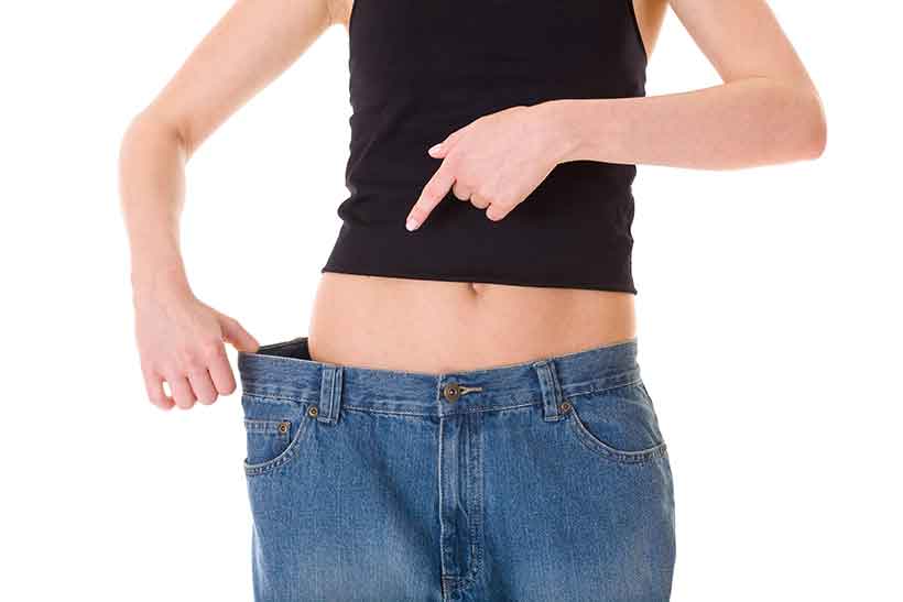 Why Reduce Carbohydrate Consumption? Woman Who Has Lost Weight; Jeans Are Now Too Big.