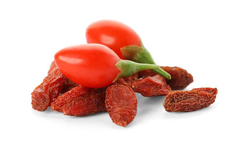 Dried Goji Berries Together With Two Fresh Goji Berries.