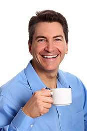 A Businessman Enjoying the Health Benefits of a Cup of Coffee.