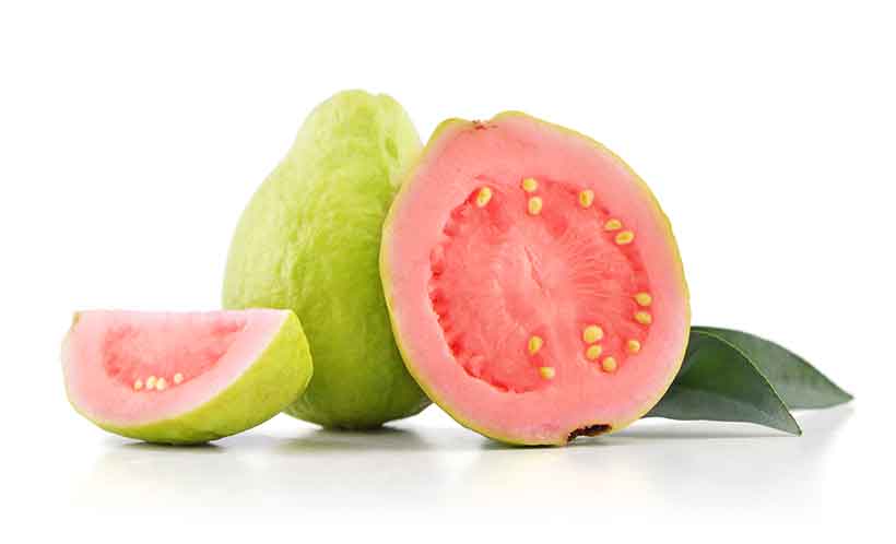 A Whole and Half Guava Fruit Showing Pink Flesh, Skin, and Seeds.