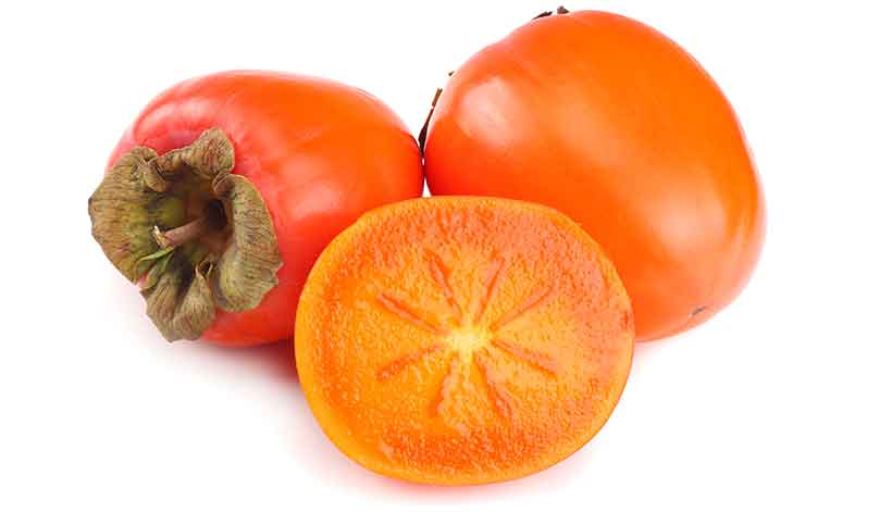 Picture Showing a Type of Persimmon Fruit Whole and Halved.