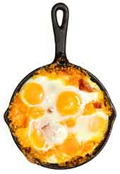 Fried Eggs and Cheese Cooking In a Cast-Iron Pan.